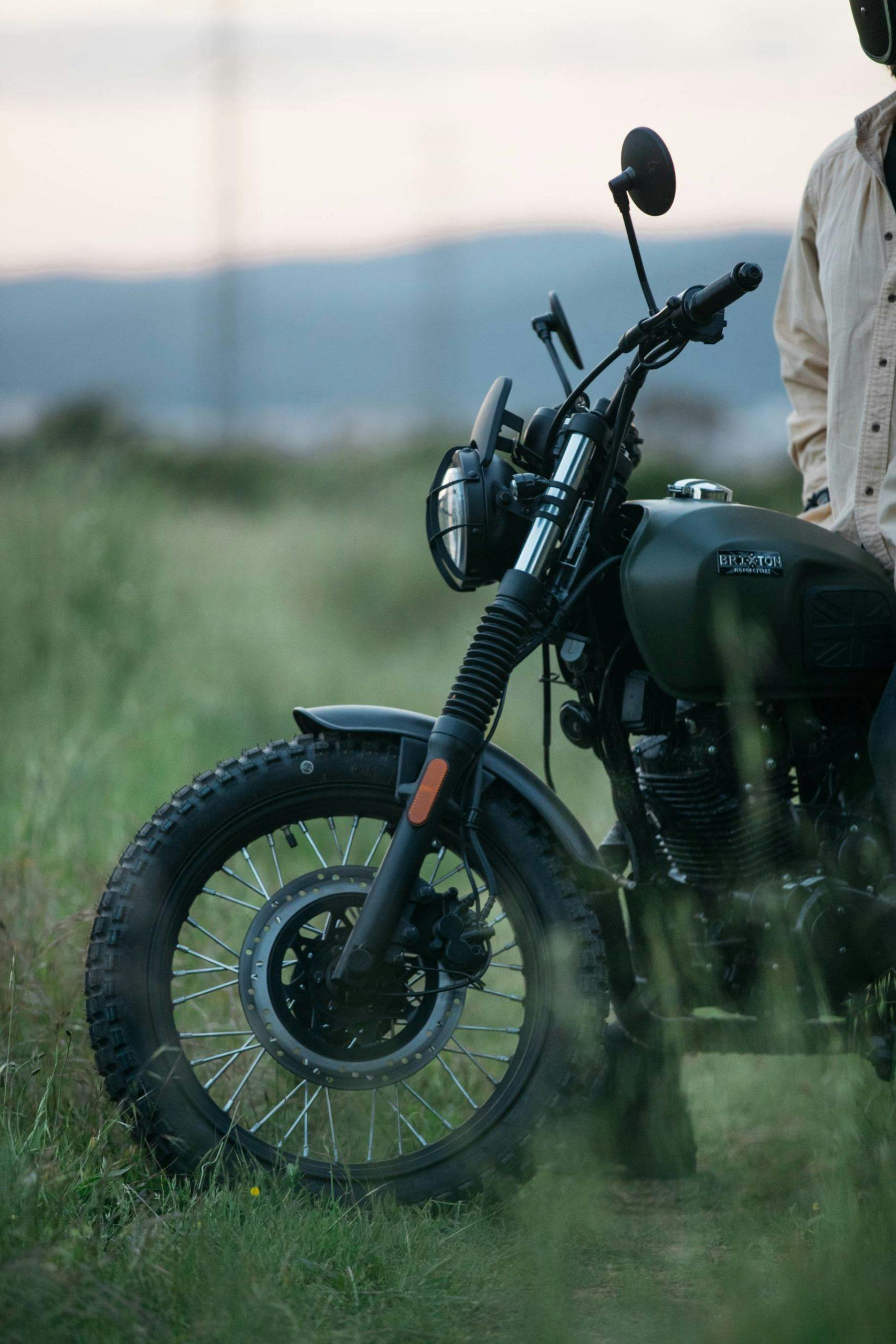Cropped close-up of the Brixton Felsberg 125 in Cargo Green parked in a field