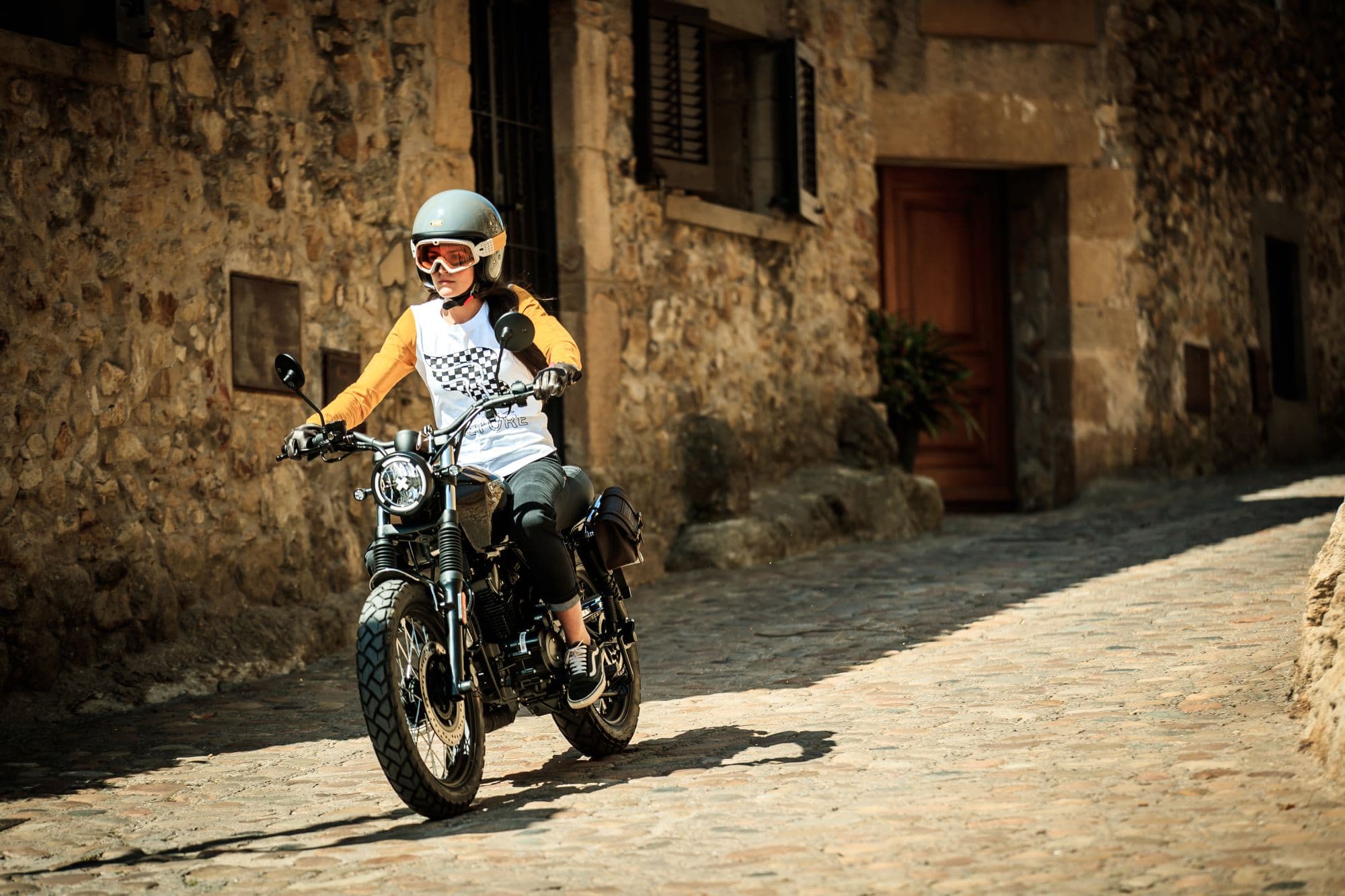 Female rider on a Brixton Cromwell 125 in Charlie Brown wearing a Brixton longsleeve