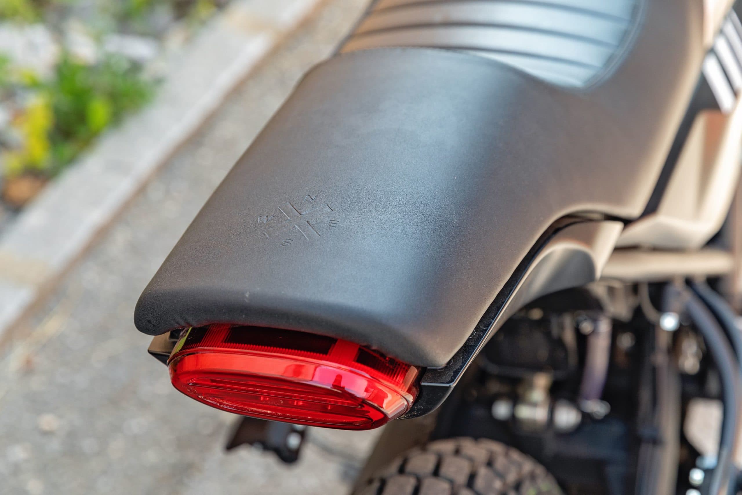 Close-up of the brake light and seat (engraved with the Brixton compass) of a Brixton Crossfire 125