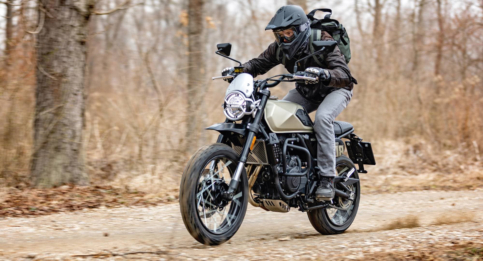 Motorcyclist riding a Crossfire 500 XC in Desert Gold Matt on a forest road