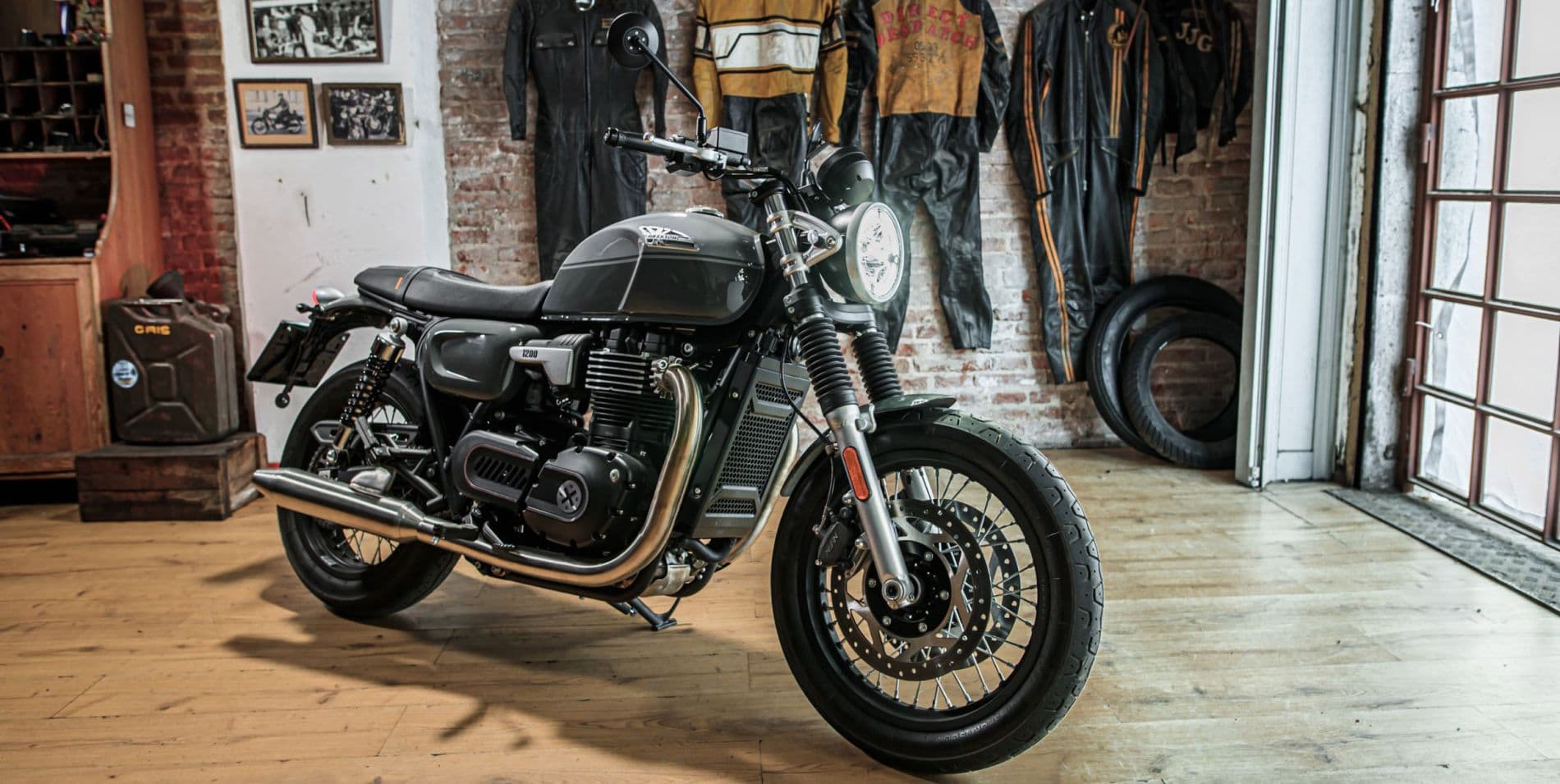Marketing Key Visual of the Brixton Cromwell 1200 in Timberwolf Grey parked in a Brixton shop/garage
