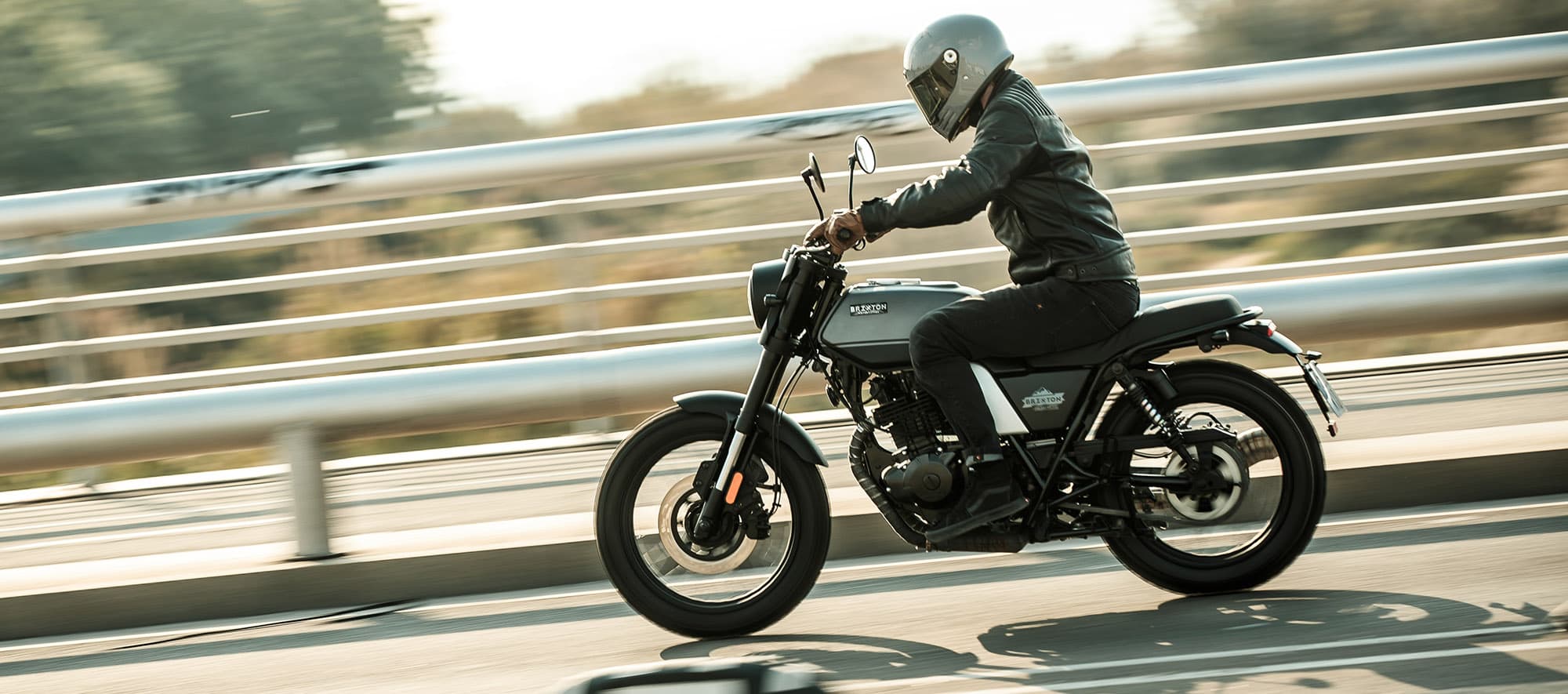 Rider on a Brixton Felsberg 250 in Timberwolf Grey going over a bdirge