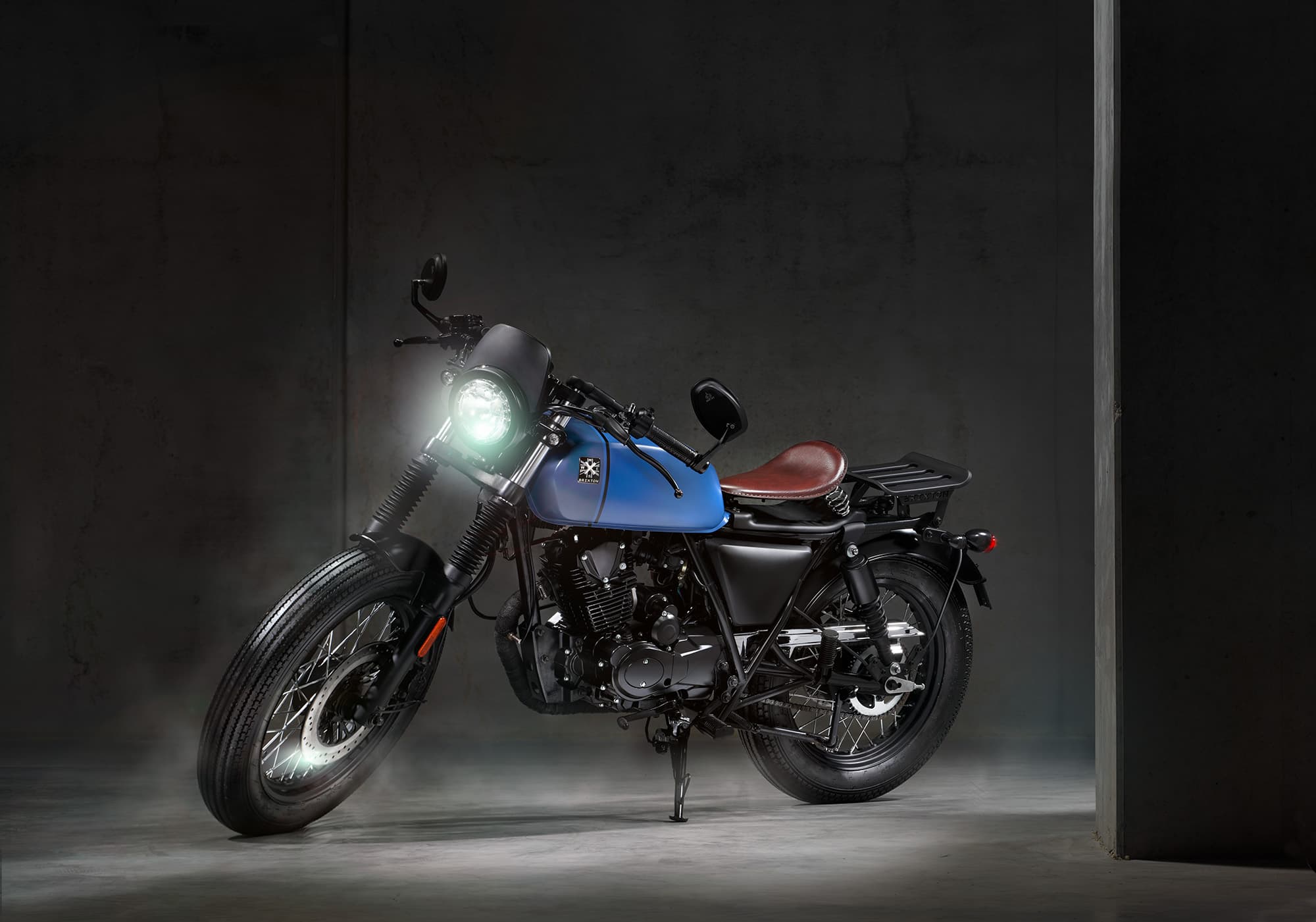 Brixton Rayburn 125 in Royal Blue Matt / Horizon Blue Matt parked in a concrete studio