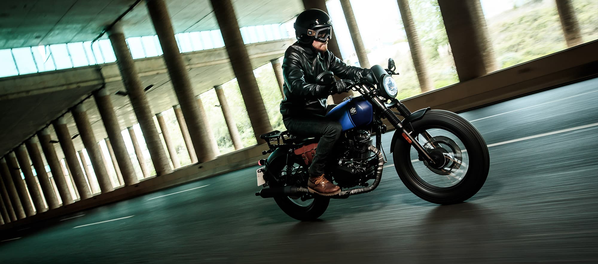 Rider on a Brixton Rayburn 125 in Royal Blue Matt / Horizon Blue Matt going through a tunnel