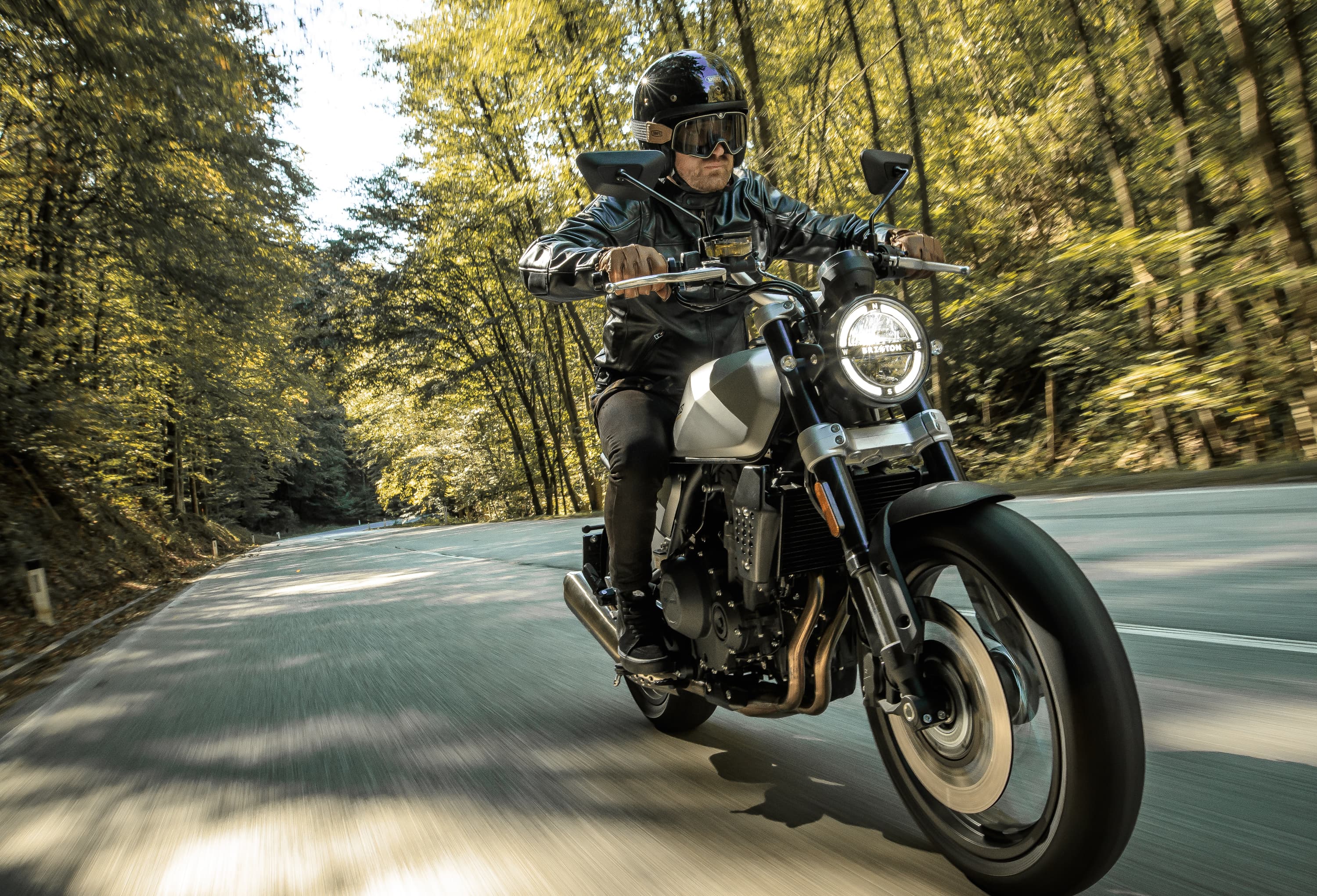 Rider on a Brixton Crossfire 500 in Bullet Silver going up a winding mountain road