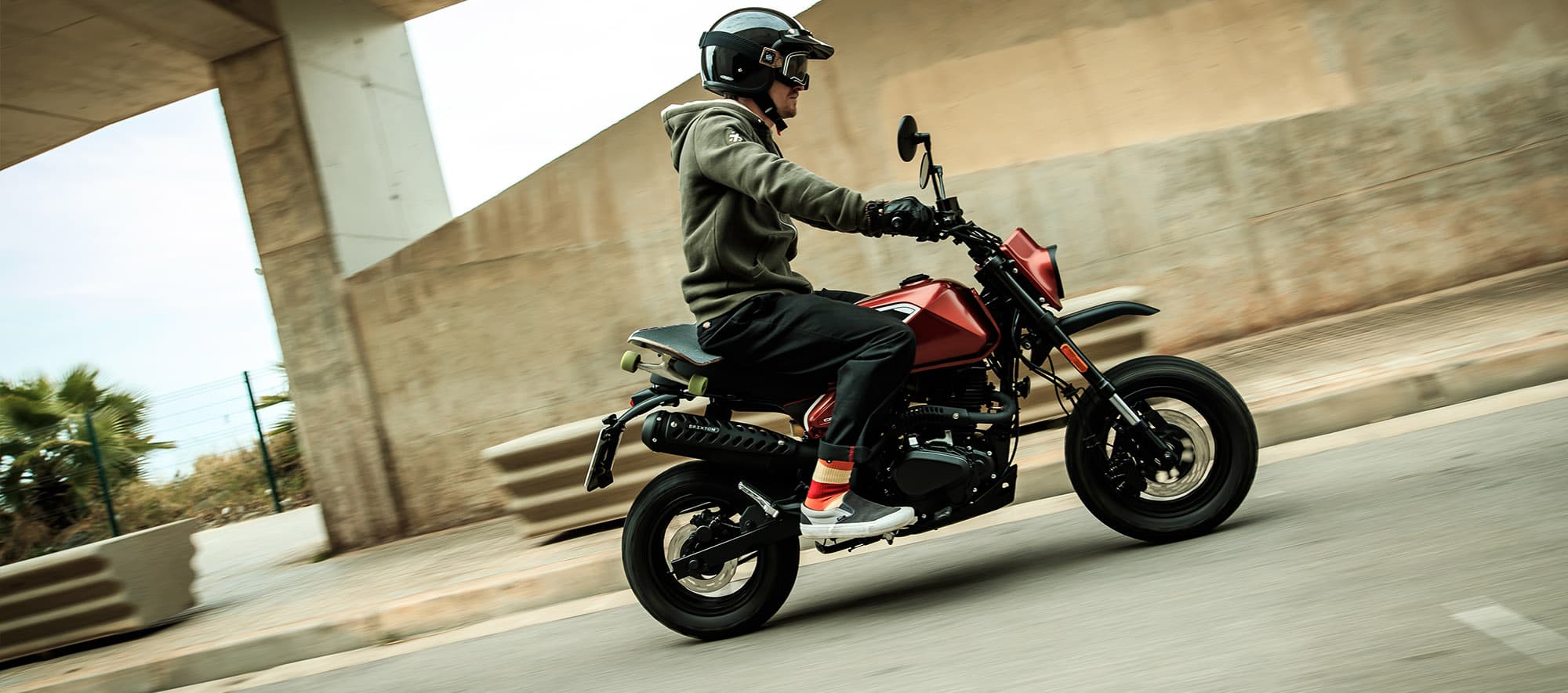 Rider on a Brixton Crossfire 125 XS in Clockwork Orange 
