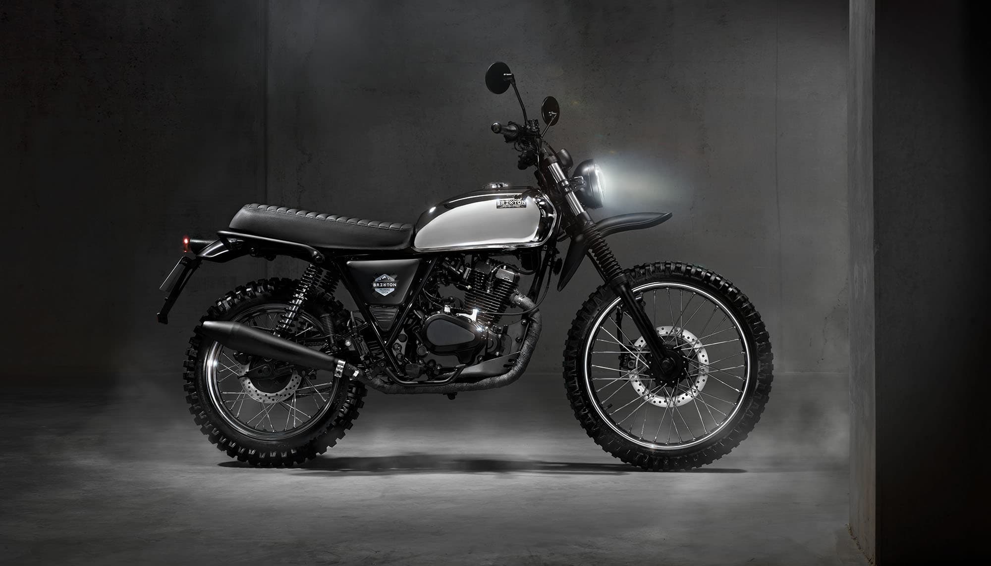Brixton Felsberg 125 XC in Quick Silver parked in a concrete studio