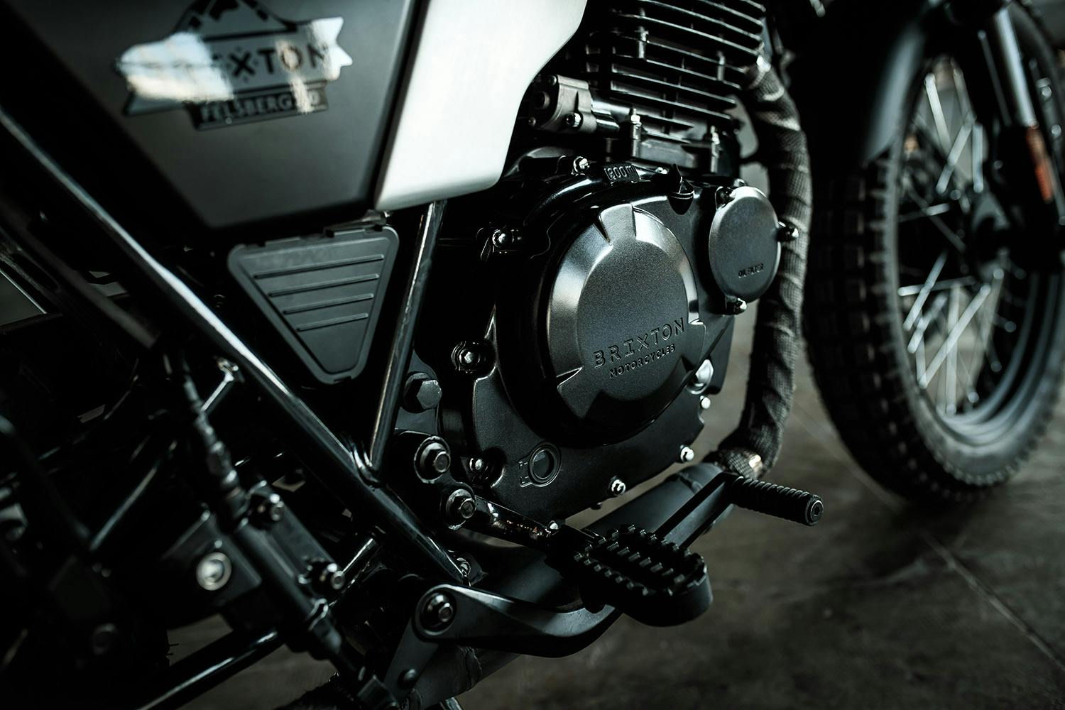 Close-up of the footrest and motor of the Brixton Motorcycles Felsberg 250 in Timberwolf Grey