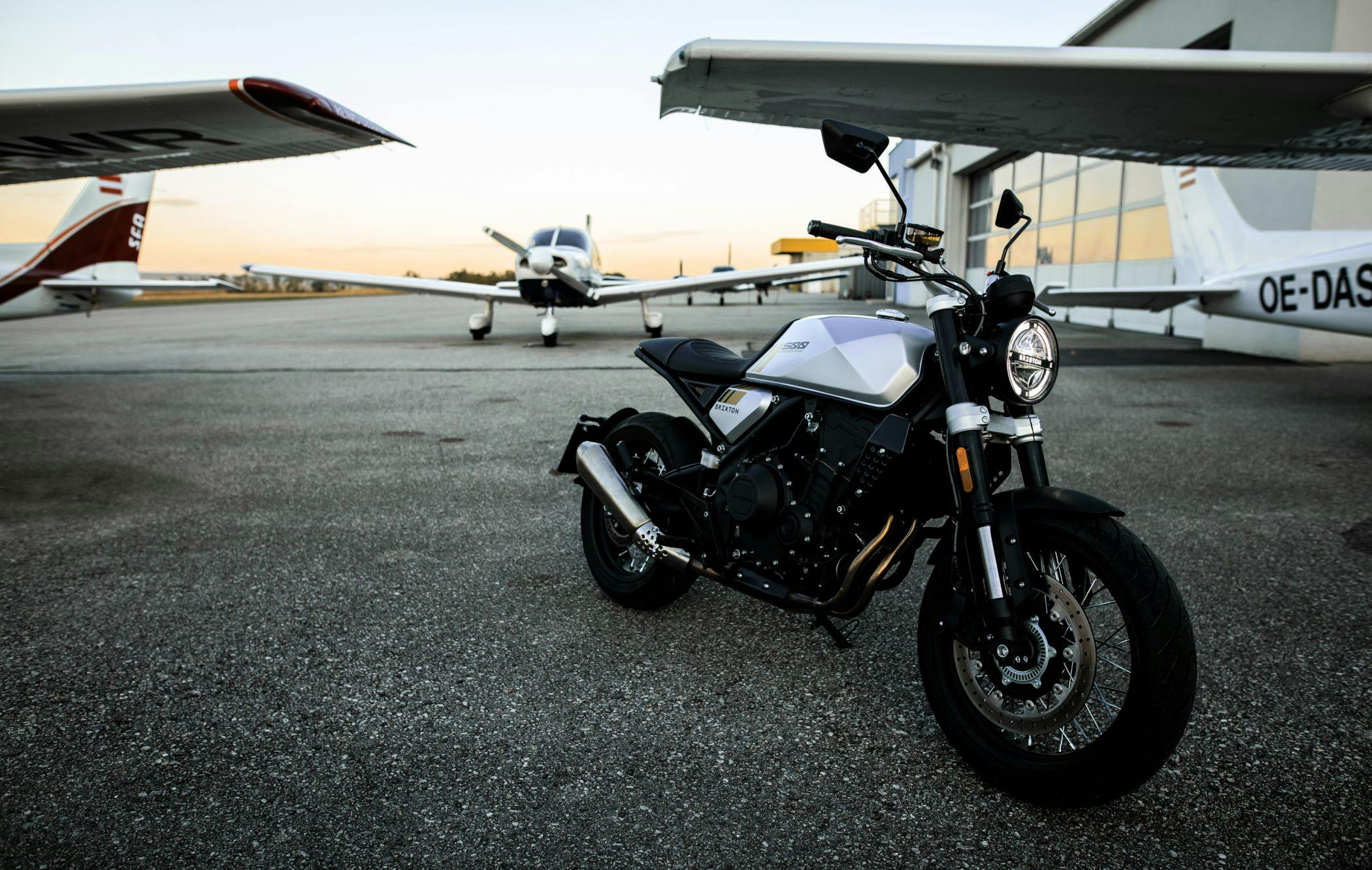 Brixton Crossfire 500 in Bullet Silver parked on an airfield at sunset