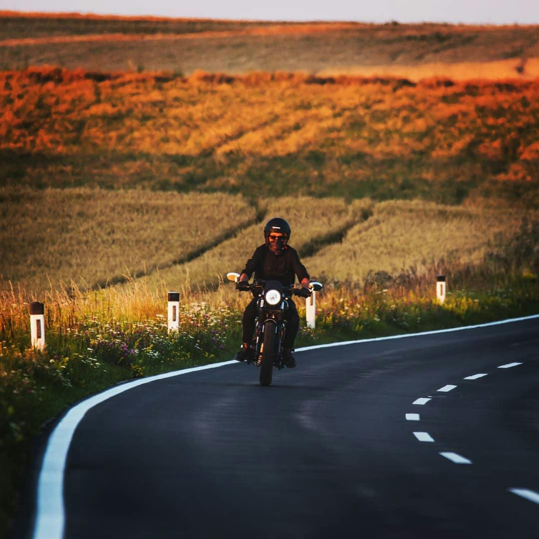 Rider of the Month: Robert on his Cromwell 125 riding on a picturesque country road at sunset
