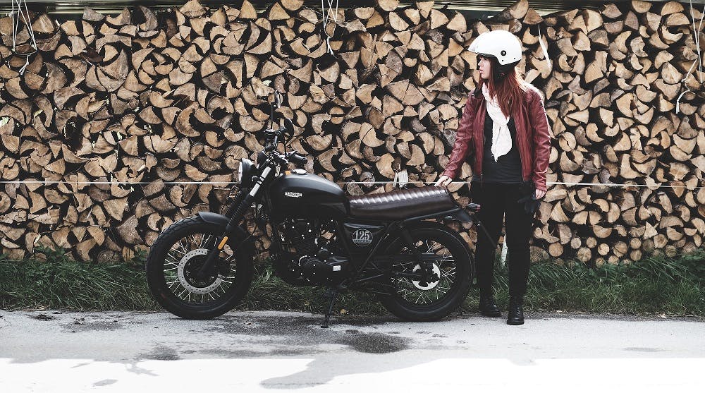 Rider of the Month Claudia standing next to her Brixton Cromwell 125 in Backstage Black