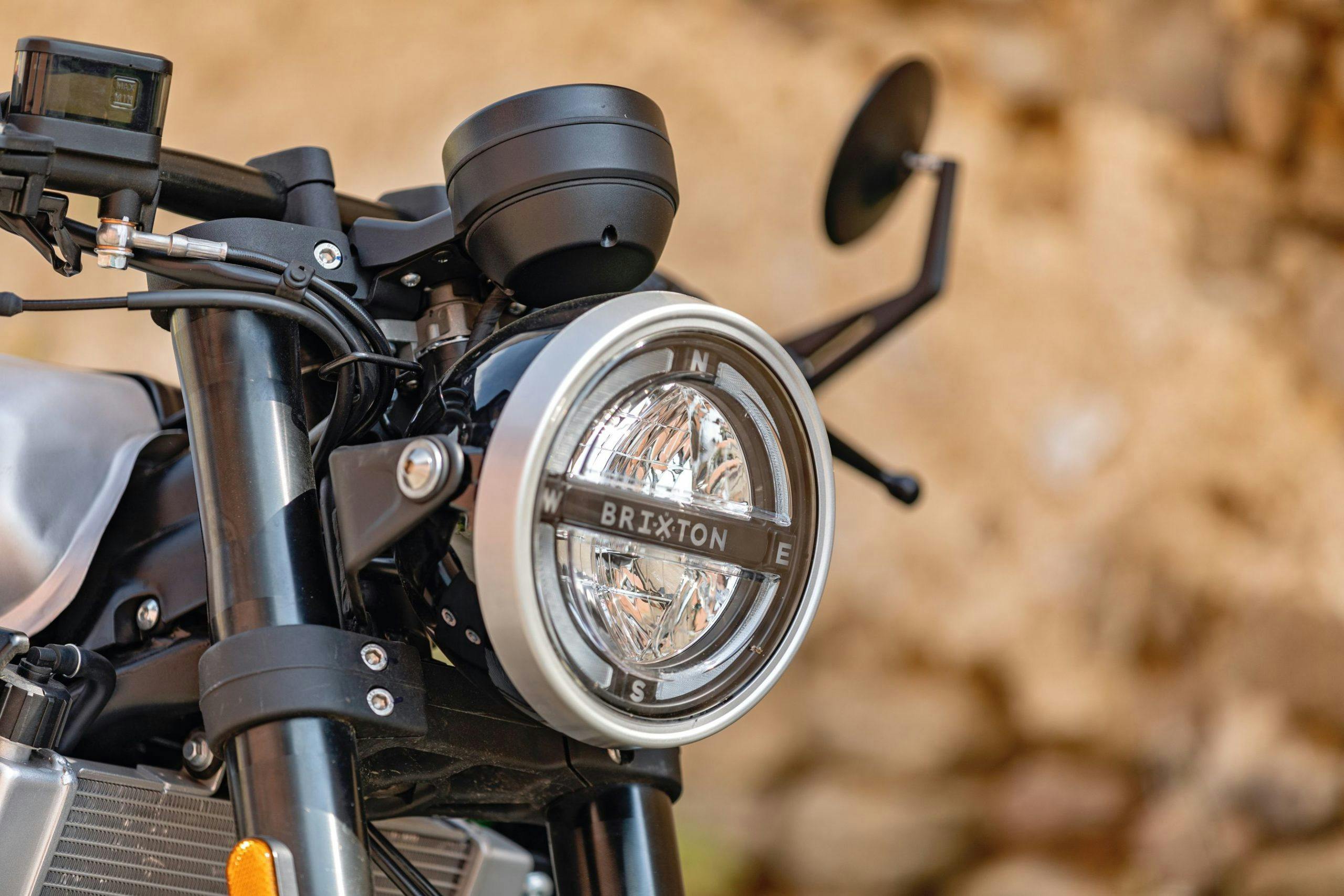 Close-up of the headlight of a a Brixton Crossfire 125 in Bullet Silver