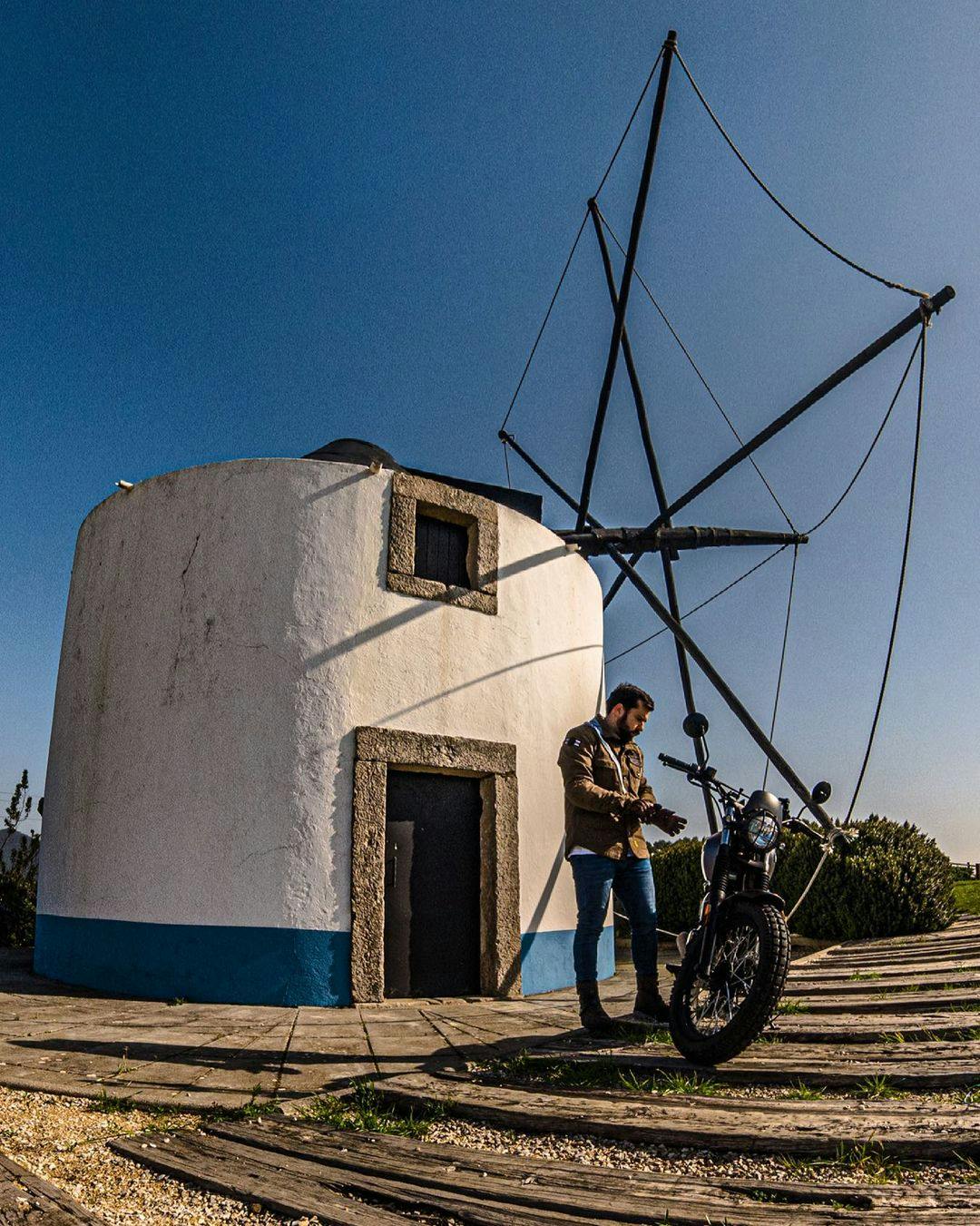 Rider of the Month John with his Brixton Felsberg 125 parked in front of an old windmill