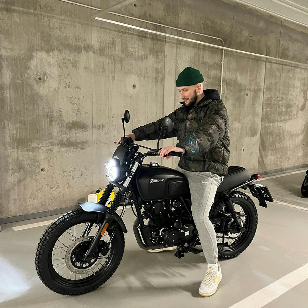 Rider of the Month Martin sitting on his Brixton Felsberg 125 in a parking garage